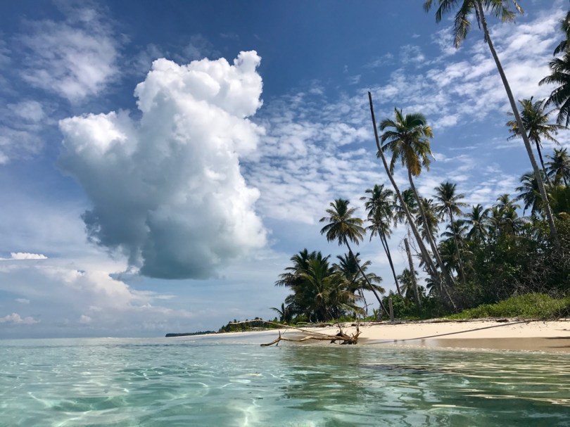 Eating coconuts, thunderheads drift by, Solo Kayaking, Kayaking, Banyak Islands, island paradise, paradise, beach, perfect beach, camping, Sumatra, Indonesia,